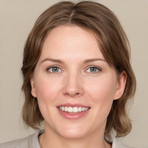 Joyful white young-adult female with medium  brown hair and blue eyes