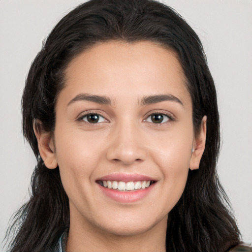 Joyful white young-adult female with long  brown hair and brown eyes