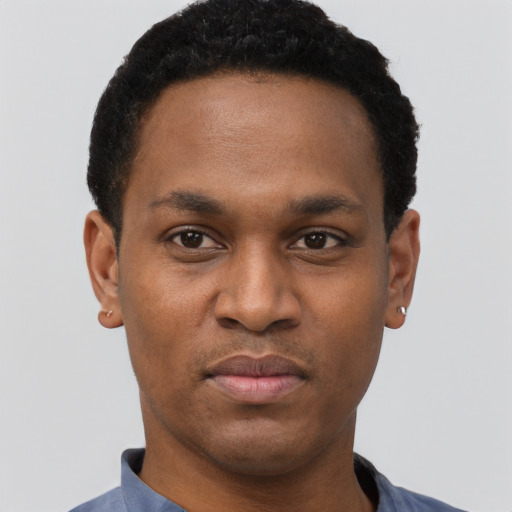 Joyful black young-adult male with short  black hair and brown eyes