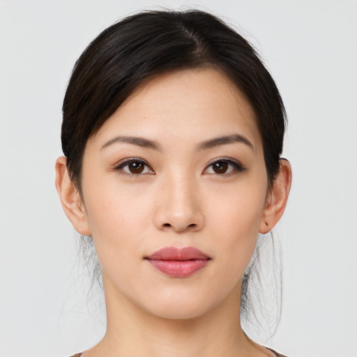 Joyful asian young-adult female with medium  brown hair and brown eyes