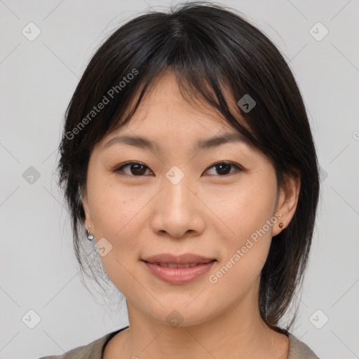 Joyful asian young-adult female with medium  brown hair and brown eyes