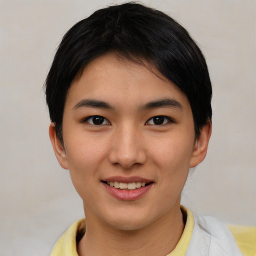 Joyful asian young-adult female with short  brown hair and brown eyes