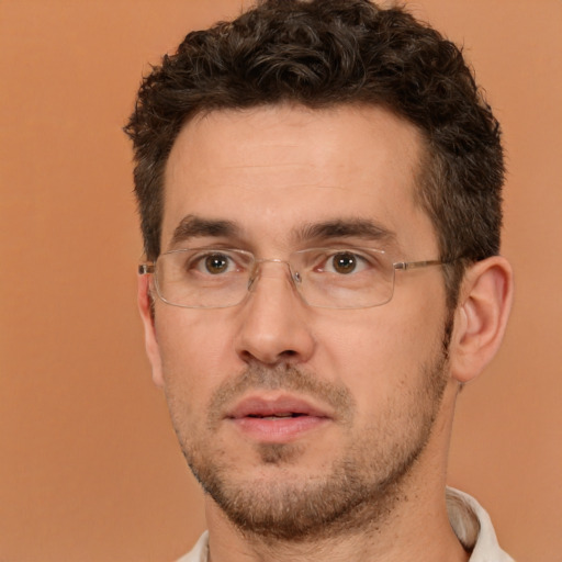 Joyful white adult male with short  brown hair and brown eyes