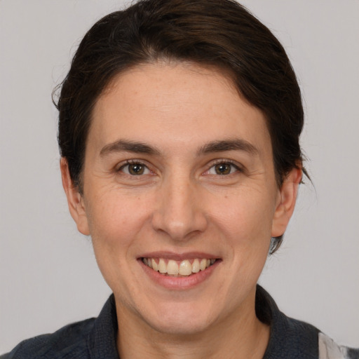 Joyful white adult female with medium  brown hair and brown eyes