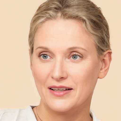 Joyful white adult female with short  brown hair and grey eyes