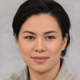 Joyful asian young-adult female with medium  brown hair and brown eyes