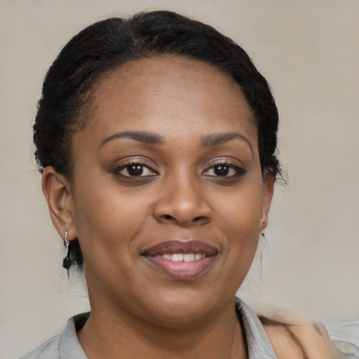 Joyful black young-adult female with medium  brown hair and brown eyes