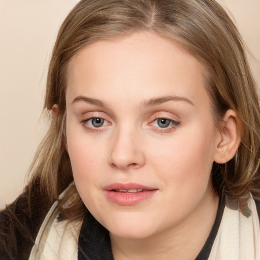 Joyful white young-adult female with medium  brown hair and blue eyes