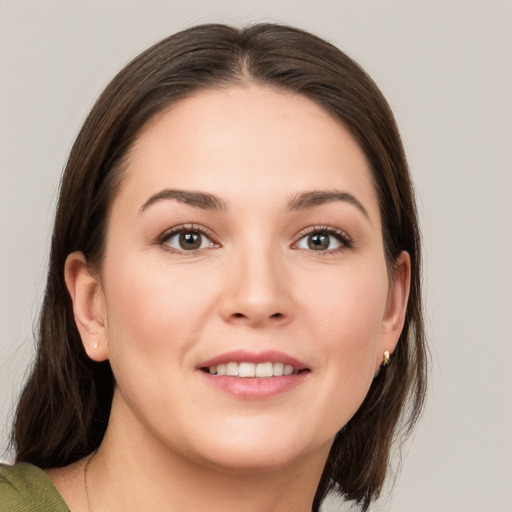 Joyful white young-adult female with medium  brown hair and brown eyes