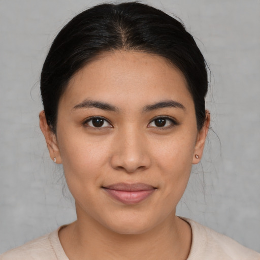 Joyful latino young-adult female with short  brown hair and brown eyes