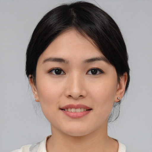 Joyful asian young-adult female with medium  brown hair and brown eyes