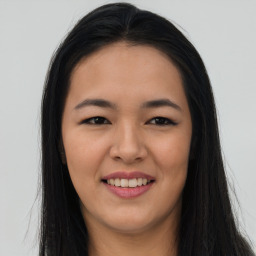 Joyful asian young-adult female with long  brown hair and brown eyes