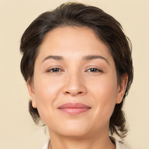 Joyful white adult female with medium  brown hair and brown eyes