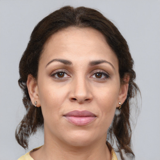 Joyful white adult female with medium  brown hair and brown eyes