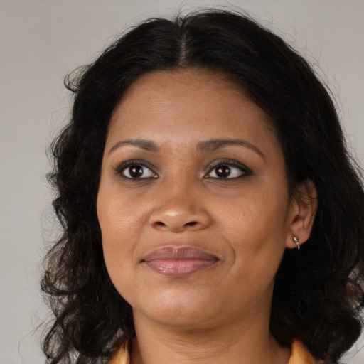 Joyful black adult female with medium  brown hair and brown eyes