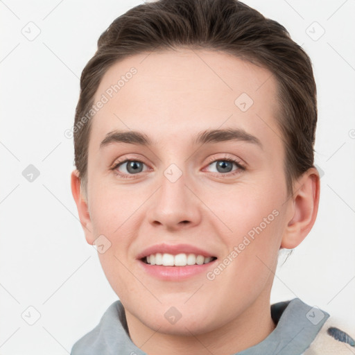 Joyful white young-adult female with short  brown hair and grey eyes