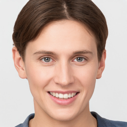 Joyful white young-adult female with short  brown hair and grey eyes