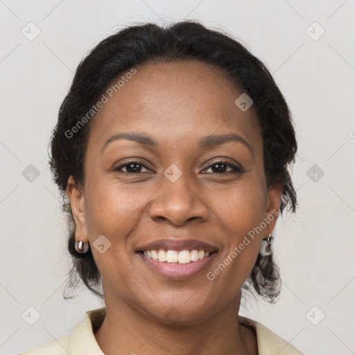 Joyful black adult female with medium  brown hair and brown eyes