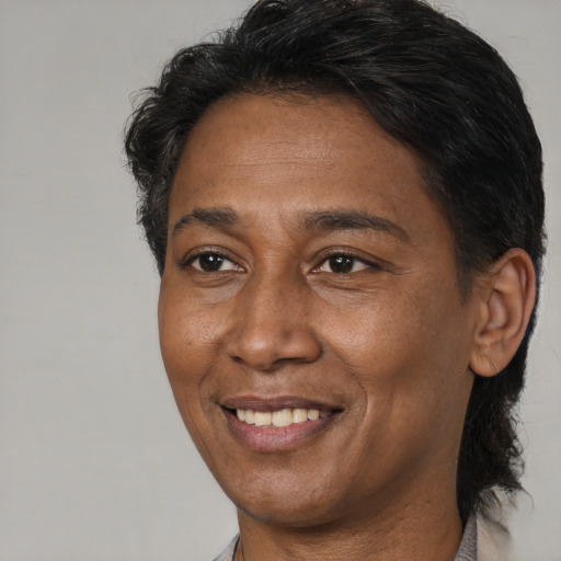 Joyful black adult female with short  brown hair and brown eyes