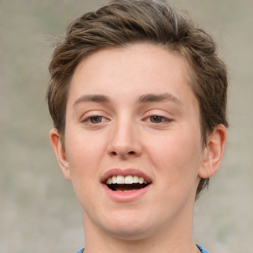 Joyful white young-adult female with short  brown hair and green eyes