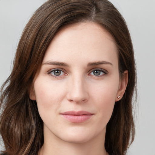 Joyful white young-adult female with long  brown hair and grey eyes