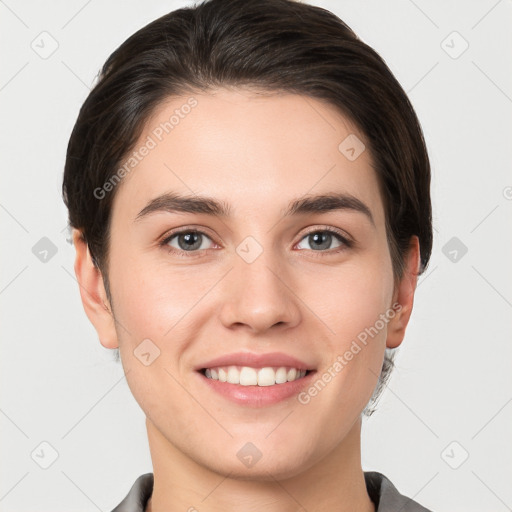 Joyful white young-adult female with short  brown hair and grey eyes