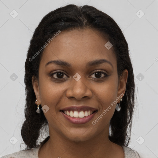 Joyful black young-adult female with long  brown hair and brown eyes