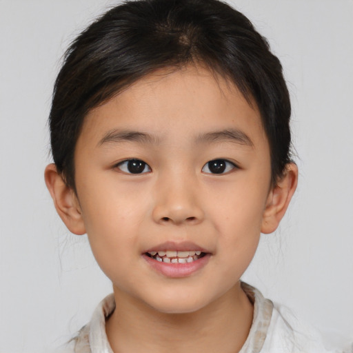 Joyful asian child male with medium  brown hair and brown eyes