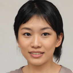 Joyful asian young-adult female with medium  black hair and brown eyes