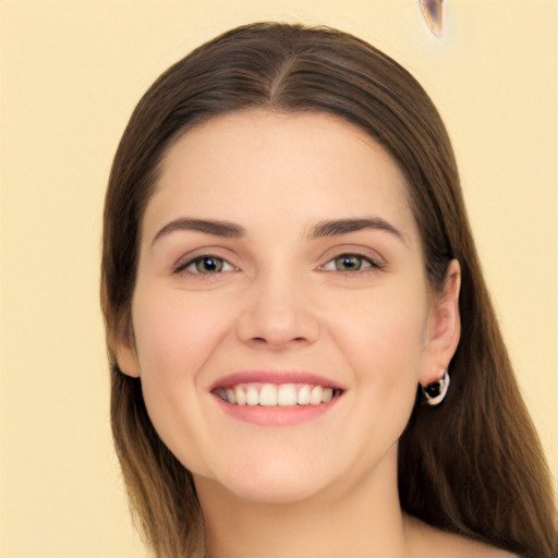 Joyful white young-adult female with long  brown hair and green eyes