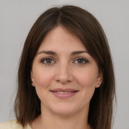 Joyful white young-adult female with medium  brown hair and grey eyes