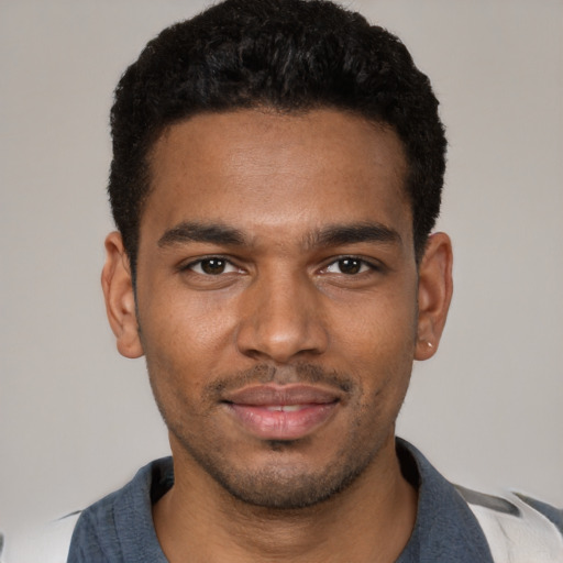 Joyful black young-adult male with short  black hair and brown eyes