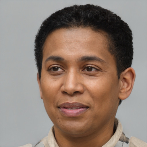 Joyful latino adult male with short  brown hair and brown eyes