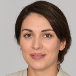 Joyful white adult female with medium  brown hair and brown eyes