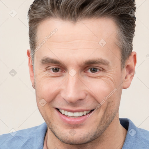 Joyful white adult male with short  brown hair and brown eyes