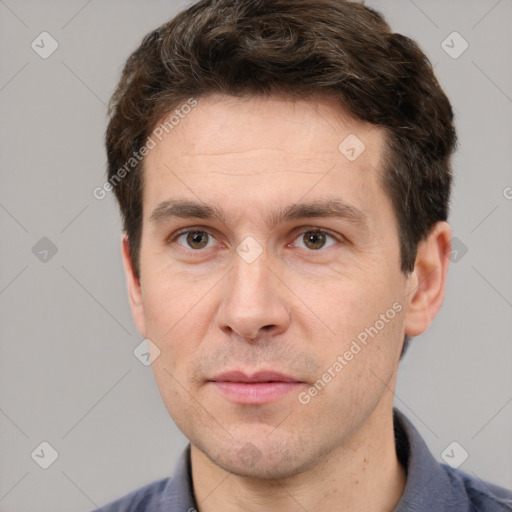 Joyful white adult male with short  brown hair and grey eyes