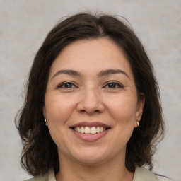 Joyful white adult female with medium  brown hair and brown eyes