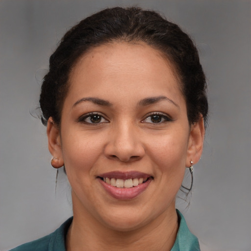 Joyful latino young-adult female with medium  brown hair and brown eyes
