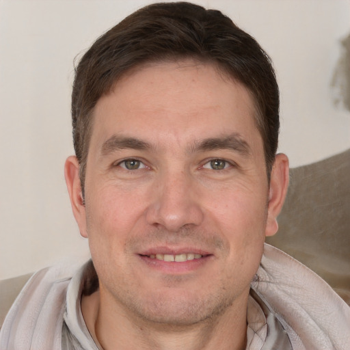 Joyful white adult male with short  brown hair and brown eyes