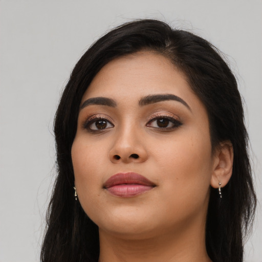 Joyful asian young-adult female with long  black hair and brown eyes