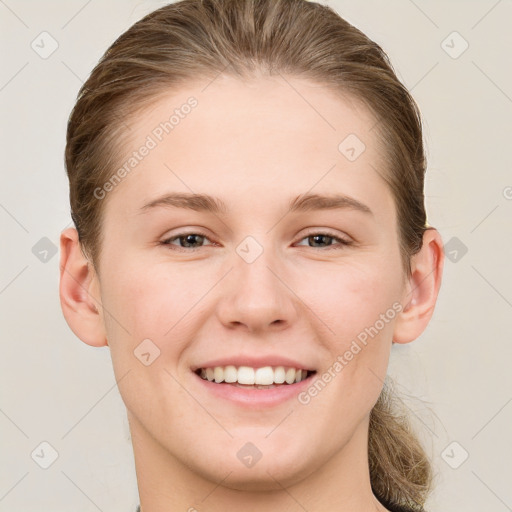 Joyful white young-adult female with short  brown hair and grey eyes