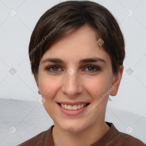 Joyful white young-adult female with short  brown hair and grey eyes