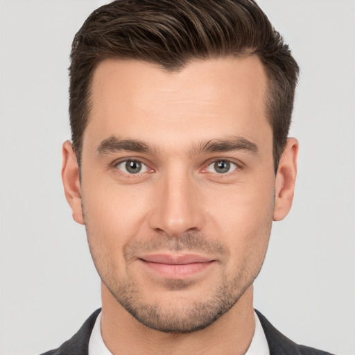 Joyful white young-adult male with short  brown hair and brown eyes