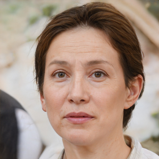 Joyful white adult female with short  brown hair and brown eyes