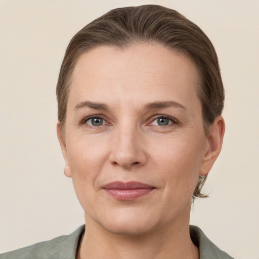 Joyful white adult female with short  brown hair and grey eyes