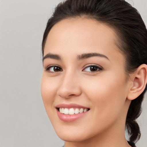 Joyful white young-adult female with long  brown hair and brown eyes