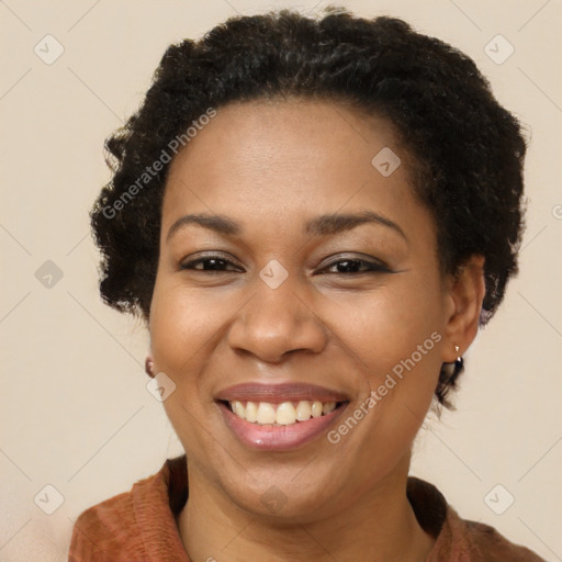 Joyful black adult female with short  brown hair and brown eyes