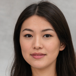 Joyful asian young-adult female with long  brown hair and brown eyes