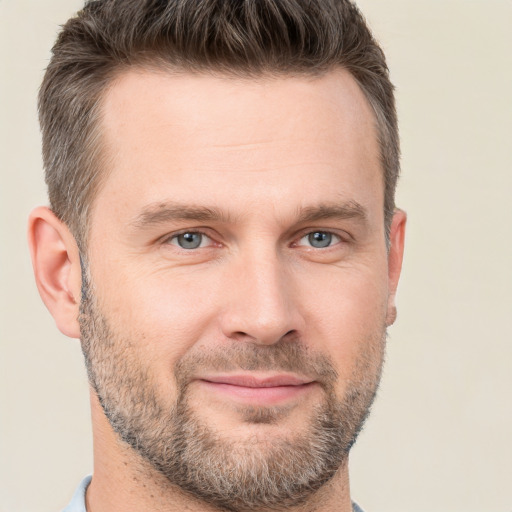 Joyful white adult male with short  brown hair and brown eyes