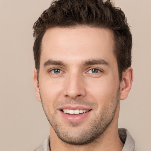 Joyful white young-adult male with short  brown hair and brown eyes